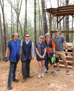 Family posing for photo on Etowah Valley Sporting Clays Blue Course in Dawsonville, GA.